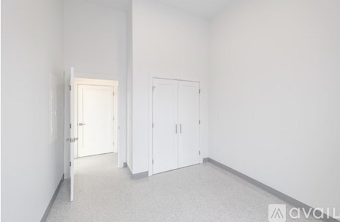 A room with a white door and a white wardrobe.