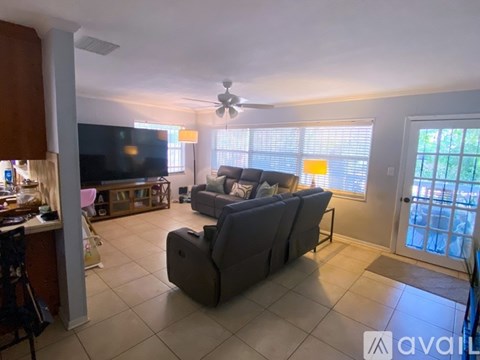 A living room with a grey couch and a television.