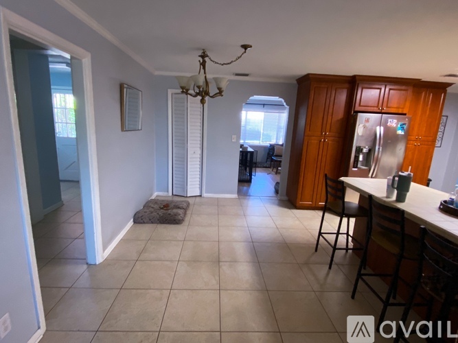 A kitchen area with a table and chairs.