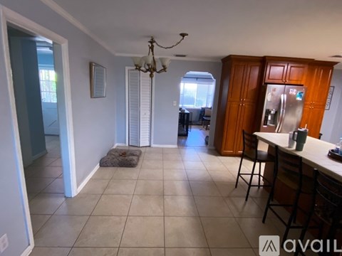 A kitchen area with a table and chairs.