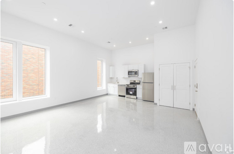 A spacious kitchen with white cabinets and a large island.