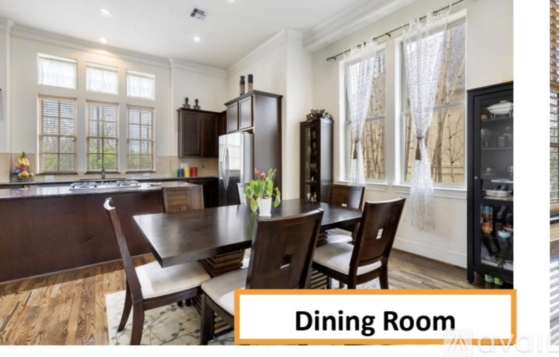 A dining room with a table set for four.