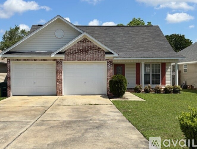 A house with a garage and a driveway in front.