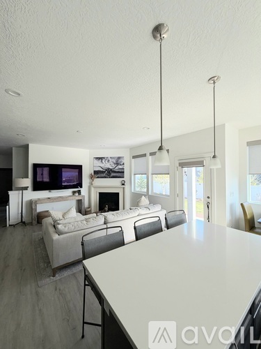 A modern living room with a white couch and a television.