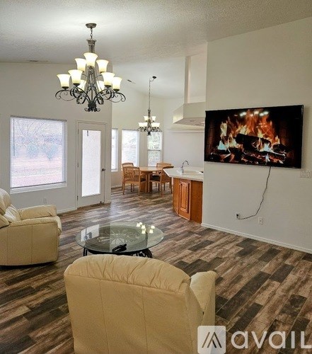 A living room with a television displaying a fireplace scene.