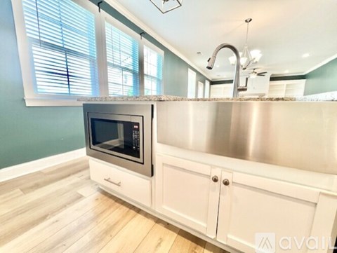 A modern kitchen with a stainless steel sink and a built-in oven.