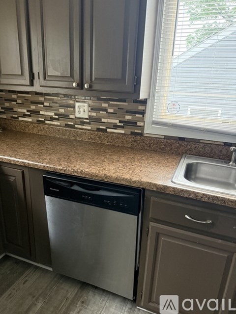 A kitchen with a dishwasher and a sink.