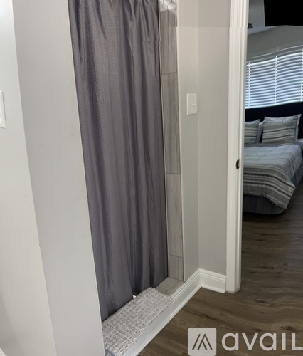 A grey curtain hangs in a white doorway.