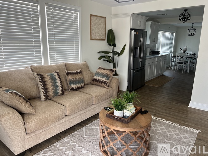 A living room with a couch, pillows, and a coffee table.