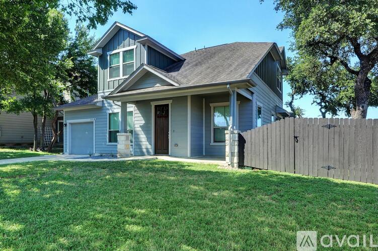 A house with a blue exterior and a brown fence.