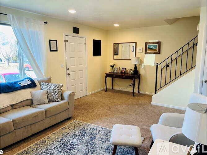 A living room with a couch, chair, and a rug.