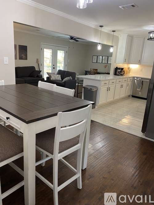 A kitchen with a table and chairs in the foreground.