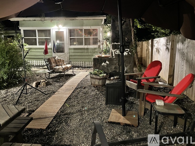 A patio area with a table and chairs under a canopy.