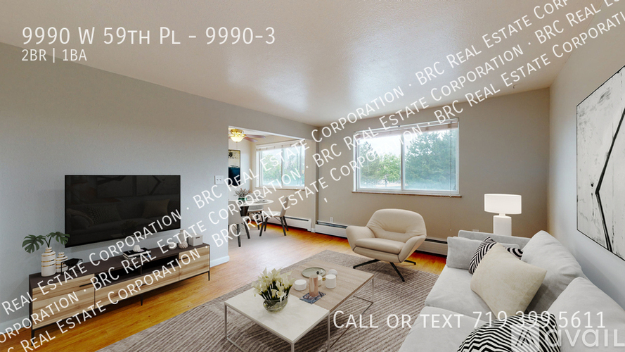 A living room with a television, a chair, a couch, and a coffee table.