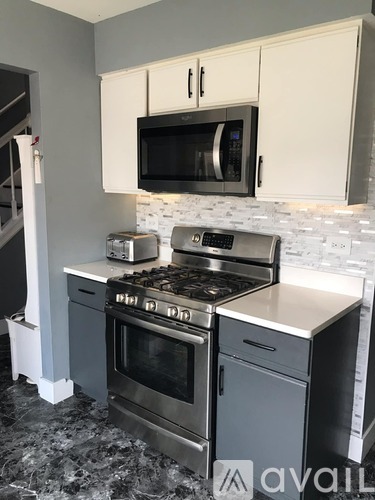 A kitchen with a stove top oven and microwave above it.