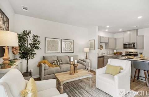 A living room with a white couch and a coffee table.