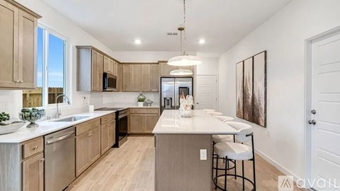 A kitchen with wooden cabinets and a white island.