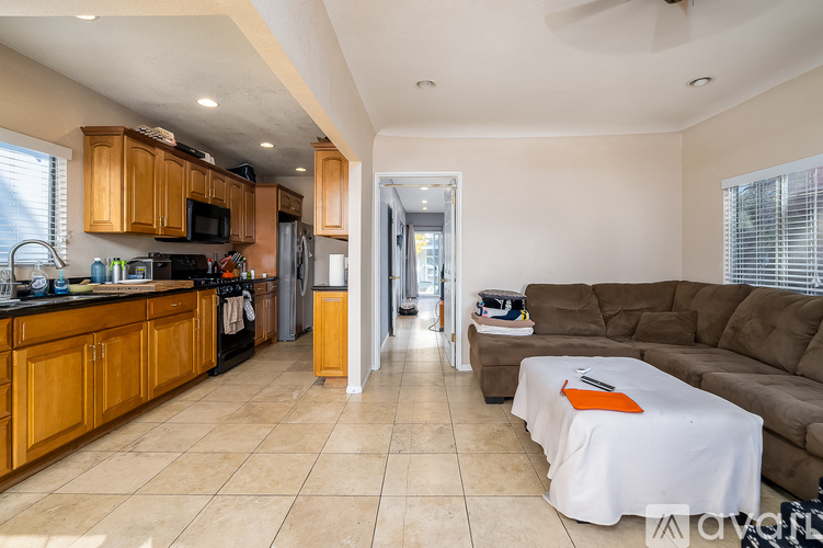 A kitchen with wooden cabinets and a black countertop with a microwave and oven.