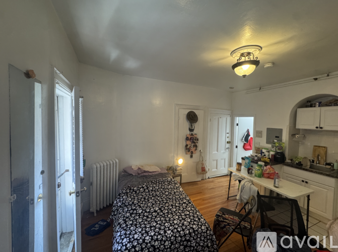 A bedroom with a bed, desk, and chair.