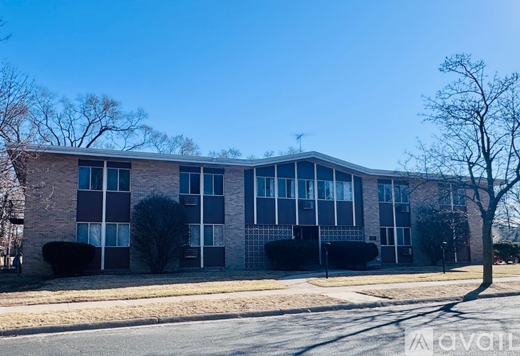 A large building with a lot of windows and a tree in front.