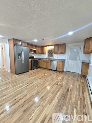 A kitchen with wooden floors and white walls.