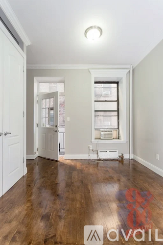 A room with wooden floors and white walls.