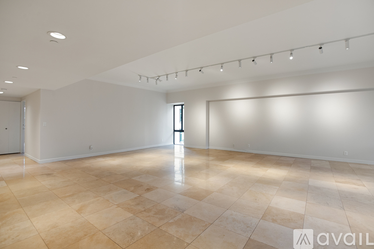 A spacious room with a tiled floor and a large window.