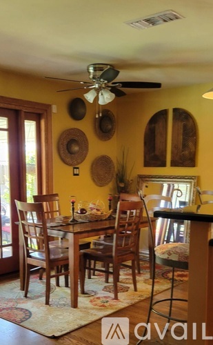 A dining room with a table and chairs.