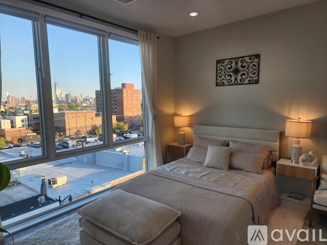 A bedroom with a large bed and a view of the city.