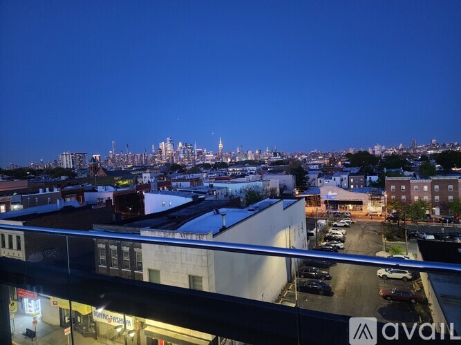 A cityscape is visible from a high vantage point at dusk.