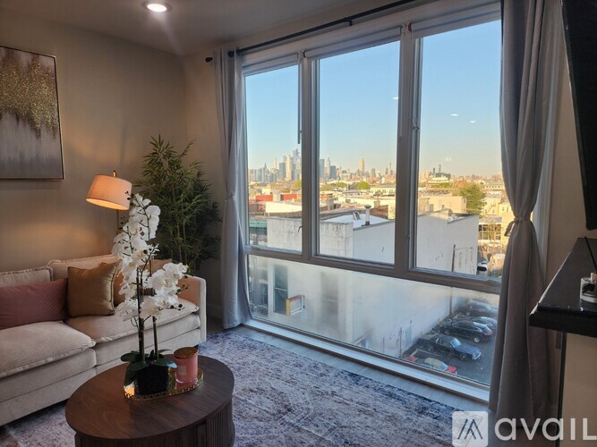 A living room with a large window overlooking a cityscape.