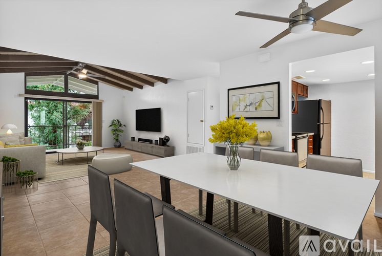 A modern dining room with a large table and chairs.