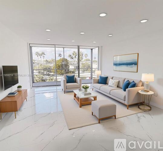A modern living room with a view of the outdoors through large windows.