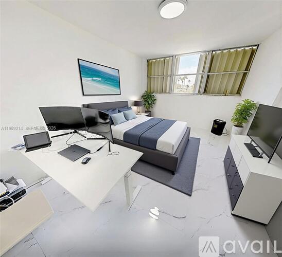 A modern bedroom with a bed, desk, and television.
