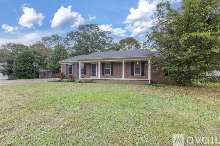 A house with a porch and a yard is for sale.