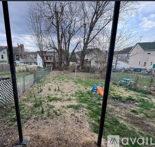A backyard with a fence and a playground.