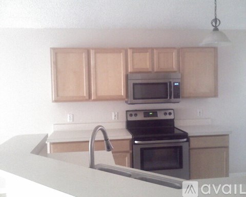 A kitchen with a stove top oven and microwave above it.