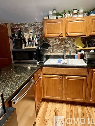 A kitchen with wooden cabinets and granite countertops.