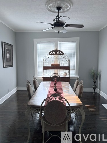 A dining room with a long table and chairs.