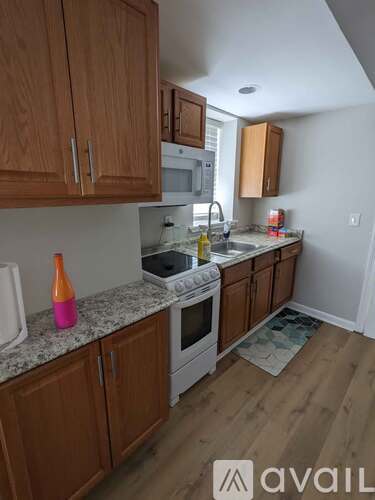 A kitchen with wooden cabinets and a granite countertop.