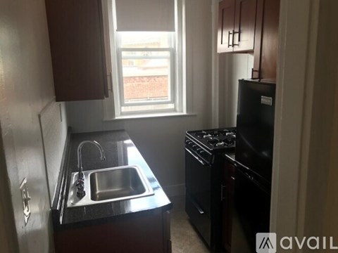 A kitchen with a sink, stove, and oven.