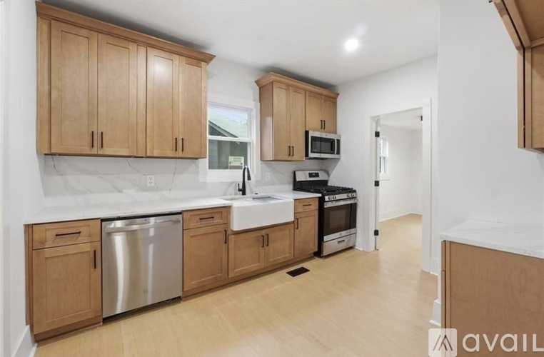 A kitchen with wooden cabinets and a white countertop.