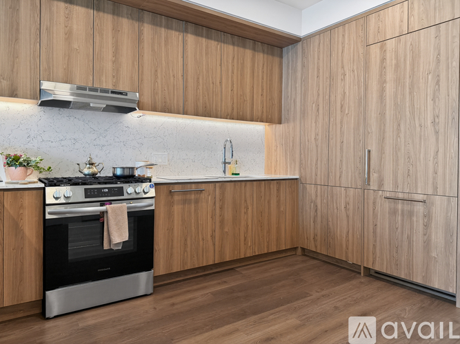 A kitchen with wooden cabinets and a black oven.