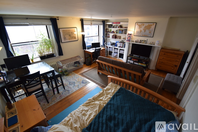 A bedroom with a bed, desk, and chair.