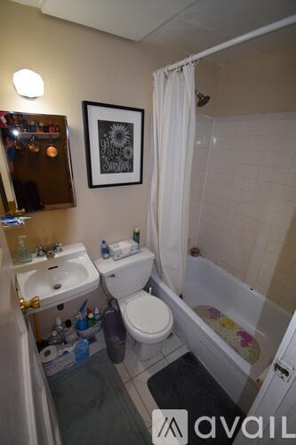 A bathroom with a toilet, sink, and bathtub.