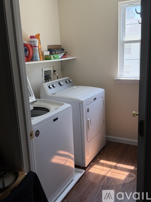 A small laundry room with a washer and dryer.