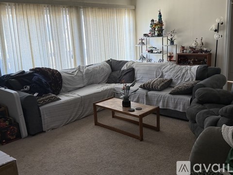 A living room with a grey couch and a wooden coffee table.