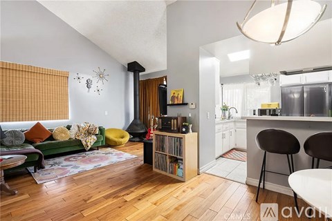A living room with a green sofa and a wooden bookshelf.