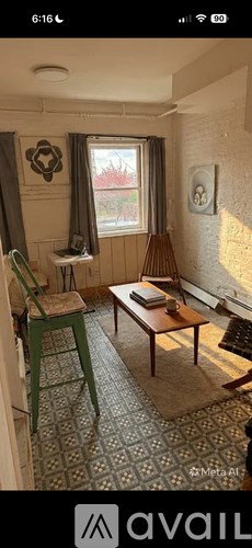A room with a table, chairs, and a window.