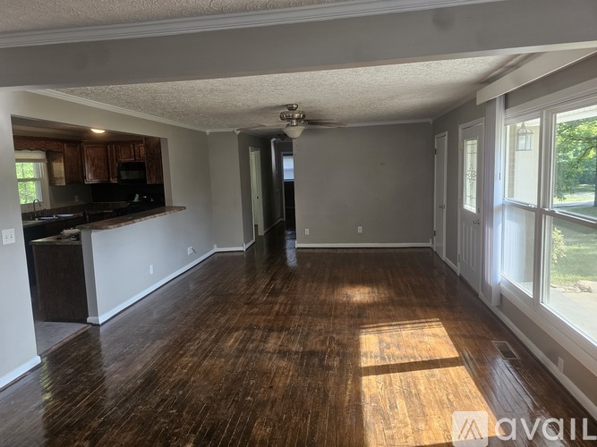 A room with wooden floors and a ceiling fan.